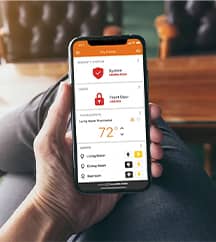 Phone in hand browsing alarm.com app