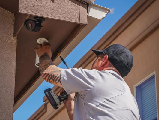 Thompson Security team installing security camera