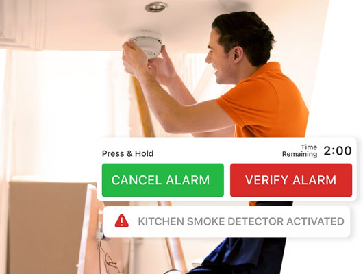 Person checking smoke detector with alarm notification overlay