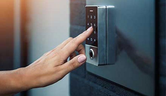 A close-up of a person's hand interacting with a smart lock