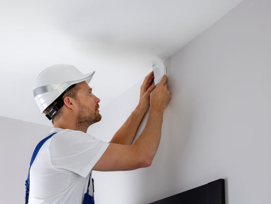 a worker installing motion sensor