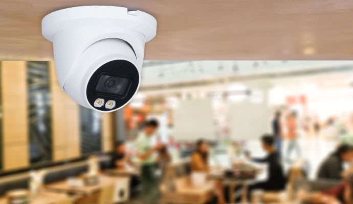 A dome security camera mounted on a ceilingn