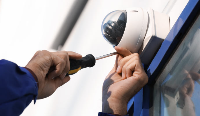 Person installing a camera on the wall